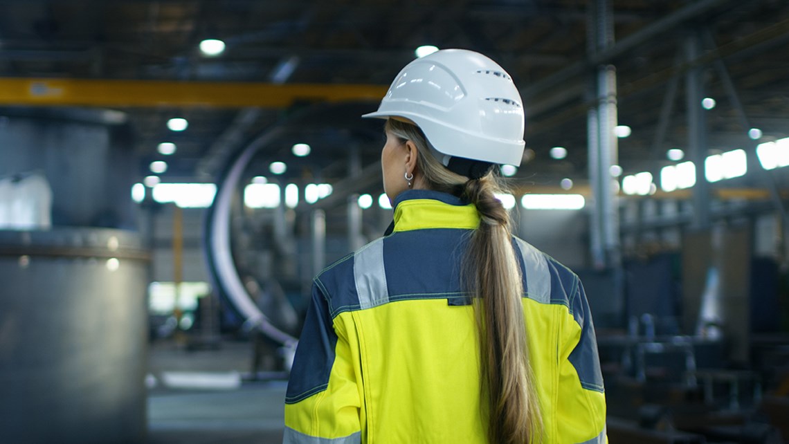 Worker seen from the back in an industrial environment